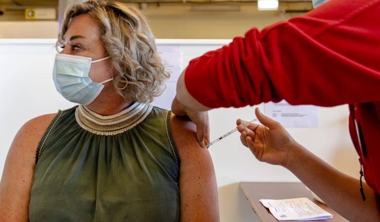 Lady in her late fourties receives a booster vaccination