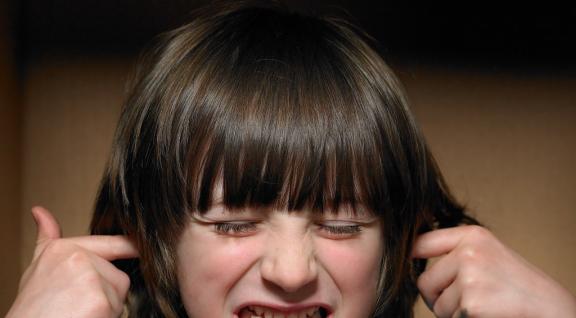 Environmental noise; girl with fingers in her ears