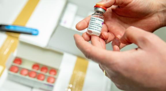 Man shows bottle AstraZeneca vaccine