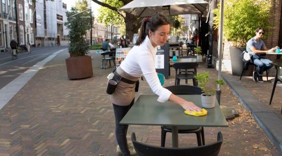 Waitress cleans patio table