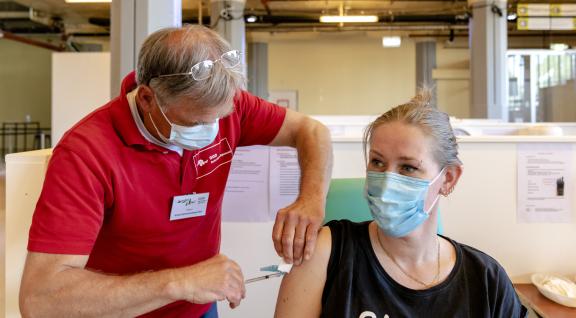 Woman receiving COVID-19 vaccination