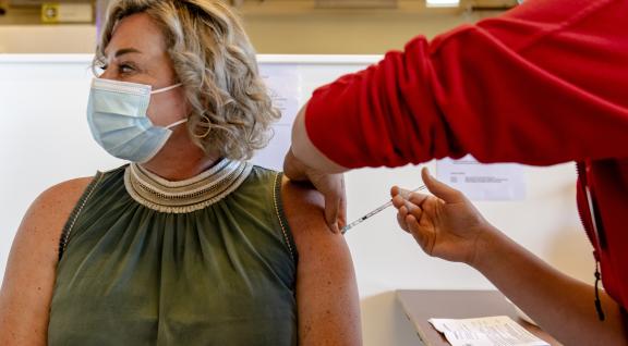 Lady in her late fourties receives a booster vaccination